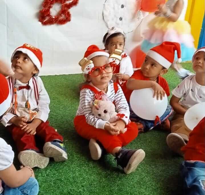 Preschool children celebrating Christmas with decorations, gifts, and festive attire in Preschool in Hinjawadi.