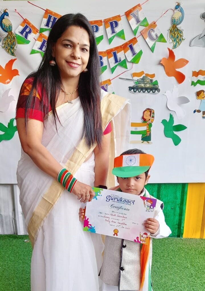 A teacher presenting certificates to a group of boys at Dr. Kamna's Gurukool Preschool.