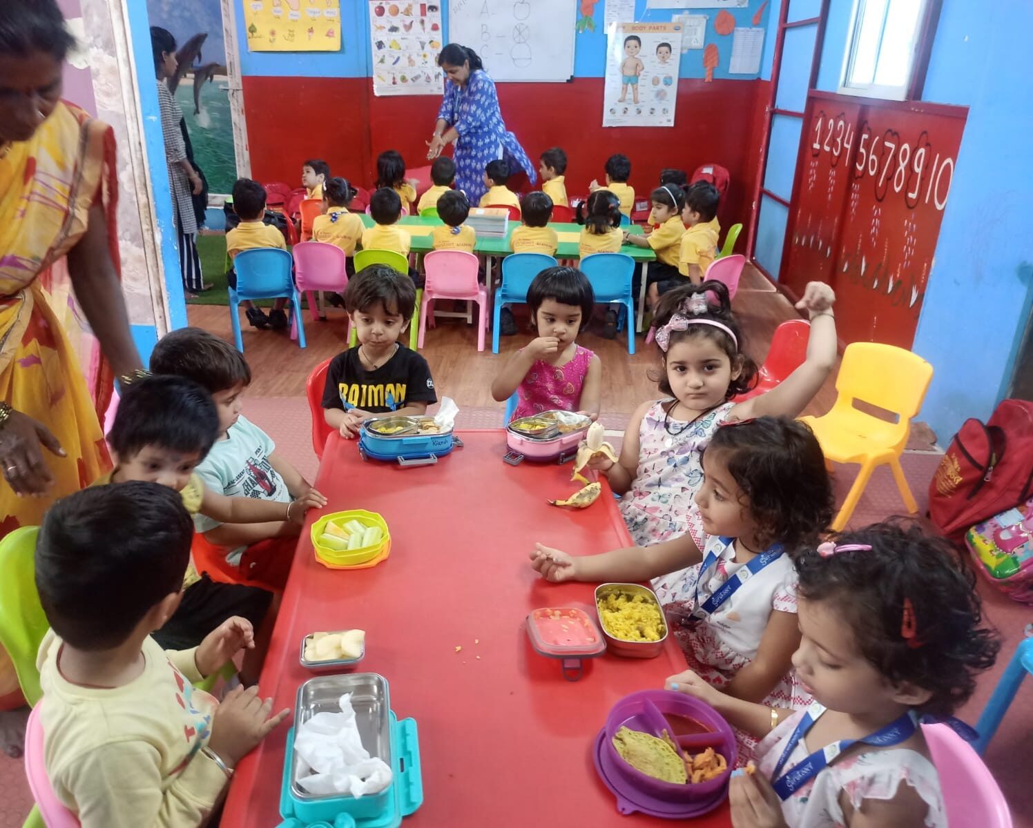 Students enjoying a healthy snack at Dr. Kamna's Gurukool Preschool.