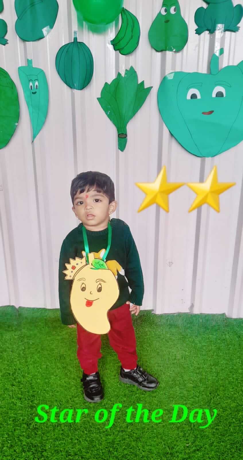 Students and teachers at Dr. Kamna's Gurukool Preschool celebrating "Green Color Day" with themed activities, decorations, and attire.