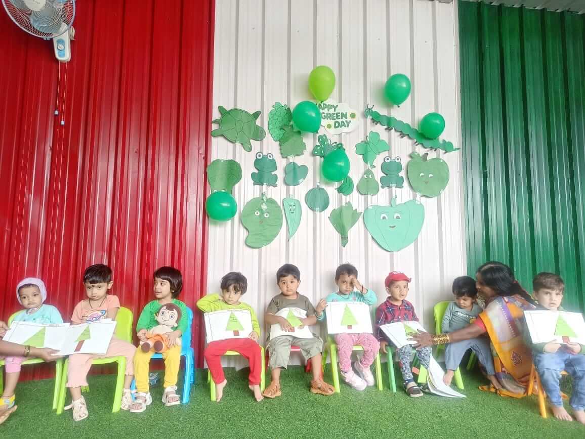 Students and teachers at Dr. Kamna's Gurukool Preschool celebrating "Green Color Day" with themed activities, decorations, and attire.