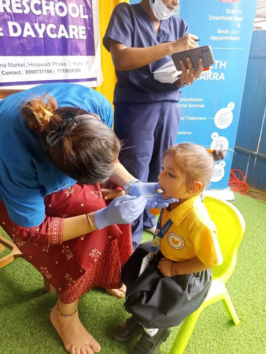 Students undergoing a dental checkup at Dr. Kamna's Gurukool Preschool.