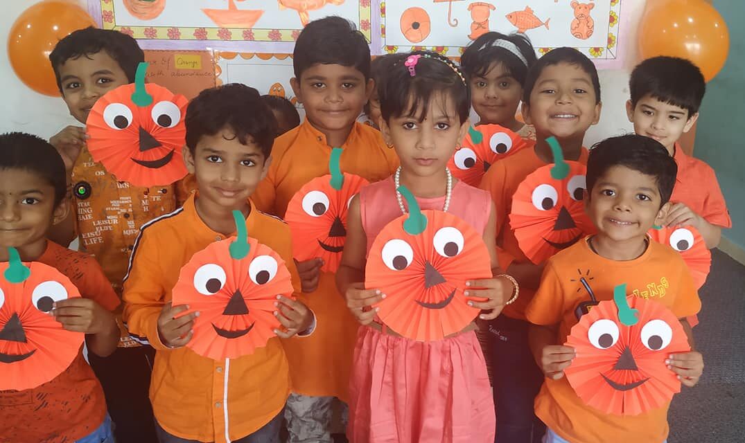 A preschool student making flowers using Goti paper, showcasing their creativity and fine motor skills at Preschool.