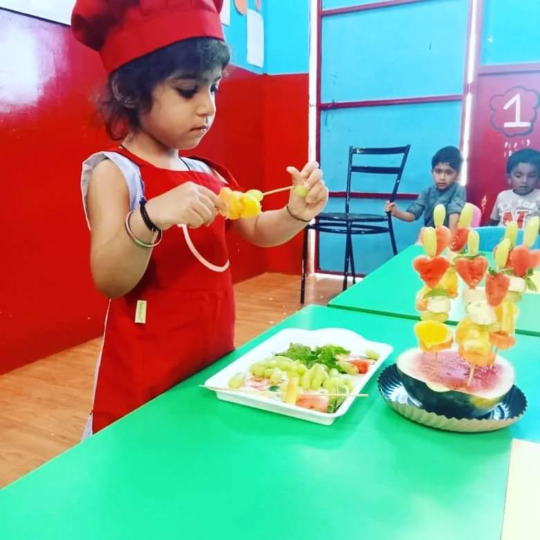 Students and teachers at Dr. Kamna's Gurukool Preschool celebrating a fun-filled summer party with games, music, and activities.